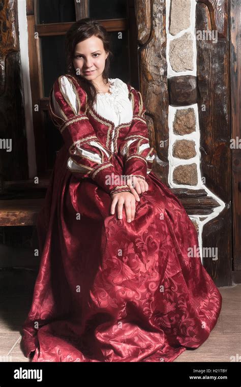 Medieval Style Portrait Of Attractive Woman In Red Dress With Wine