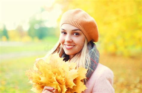 Portrait Beautiful Smiling Woman With Yellow Maple Leafs In Warm Sunny