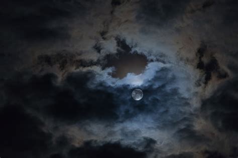 Premium Photo | Full moon in the clouds in the night sky