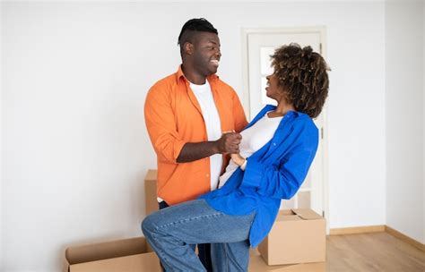 Premium Photo Romantic Black Couple Dancing Among Unpacked Cardboard