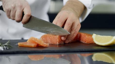 Premium Photo Chef Cutting Salmon Fillet At Kitchen Closeup Hands