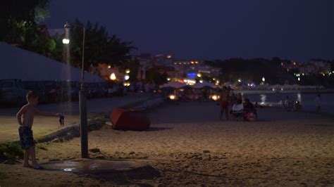 Beach with people in resort town at night, Greece 28747583 Stock Video