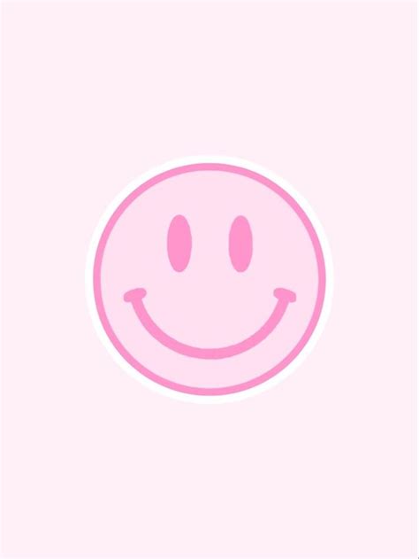 A Pink Smiley Face Sticker On A White Background