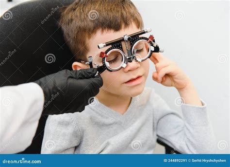 Cheerful Child Boy In Glasses Checks Eye Vision Pediatric