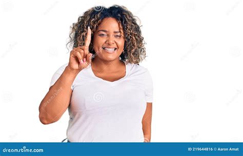 Young African American Plus Size Woman Wearing Casual Clothes Showing