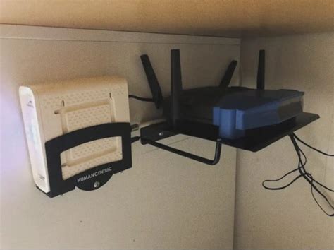 Two Routers Are Hanging On The Wall Next To Each Other With Wires Running Through Them