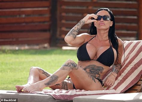 Katie Price Puts On A Busty Display In A Plunging Black Bikini As She Relaxes By The Pool With