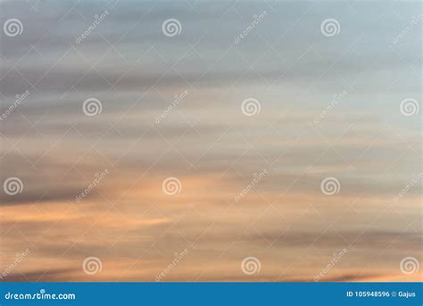 Sunset Sky Background With A Golden Orange Glow On A Hazy Clouds Stock