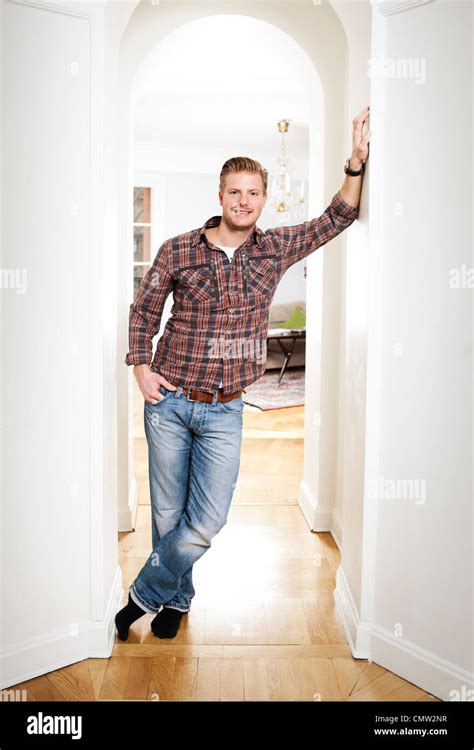 Portrait Of Mid Adult Man Standing In Doorway At Home Stock Photo Alamy