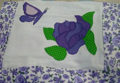 A Close Up Of A Flower And Butterfly On A White Cloth With Purple