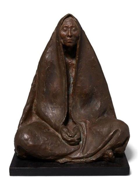 A Bronze Statue Of A Woman Wrapped In A Blanket On A Black Base With A