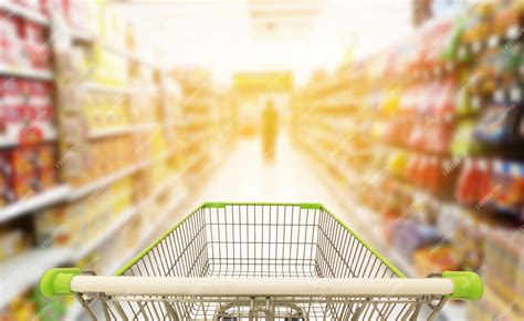 Premium Photo | Shopping cart in blur supermarket background