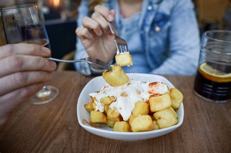 Lesbian Couple Sharing Patatas Bravas With Alioli And Vermouth On Valentine S Day Stock Photo