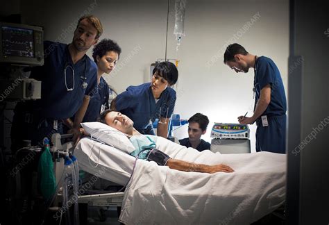 Group Of Doctors Caring For Patient Ward Stock Image F014 6892