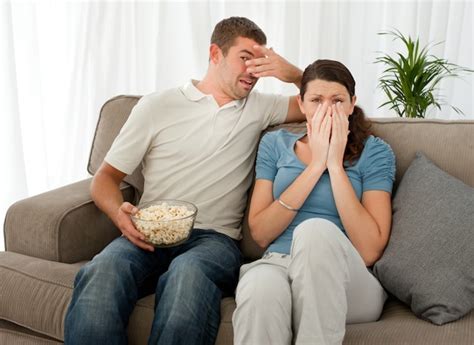 Premium Photo Scared Couple Eating Pop Corn While Watching A Horror Movie