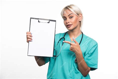 Free Photo Female Doctor Holding A Clipboard Pointing Finger On White Surface