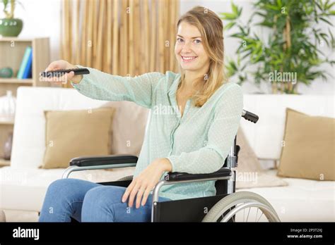 Disabled Woman In Wheelchair Watching Movies At Home Stock Photo Alamy