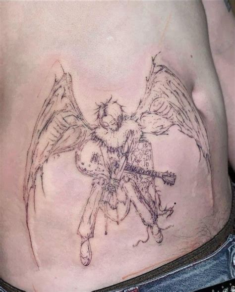 A Man With An Angel Tattoo On His Stomach