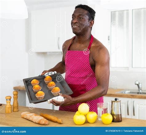 Man in Apron Holding Baking Sheet with Cupcakes Stock Image - Image of ...