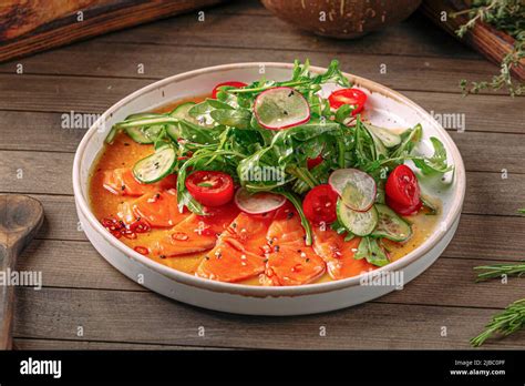 Plate of gourmet salmon carpaccio salad Stock Photo - Alamy