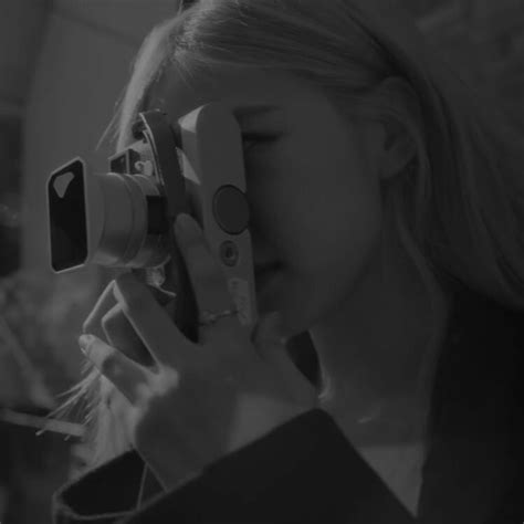 A Woman Taking A Photo With Her Camera In Black And White While She Is