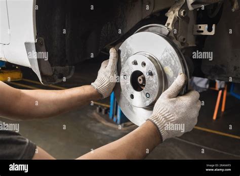 Auto Mechanic Installs New Brake Discs For The Brake System Of A