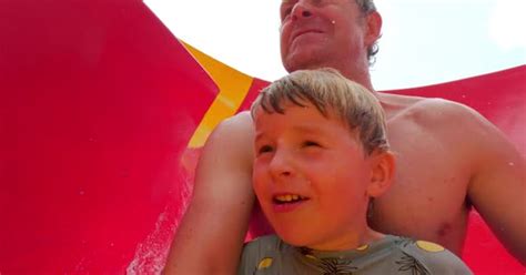 Father And Son Sliding Together On A Water Slide Stock Video Envato