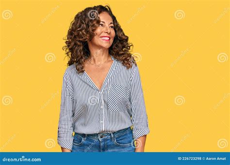 Middle Age Hispanic Woman Wearing Casual Clothes Looking Away To Side