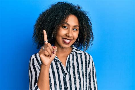 Beautiful African American Woman With Afro Hair Wearing Casual Clothes Smiling With An Idea Or