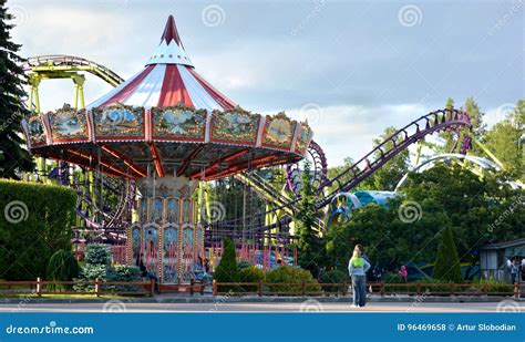 Carousel And Roller Coaster In An Amusement Park Editorial Stock Photo