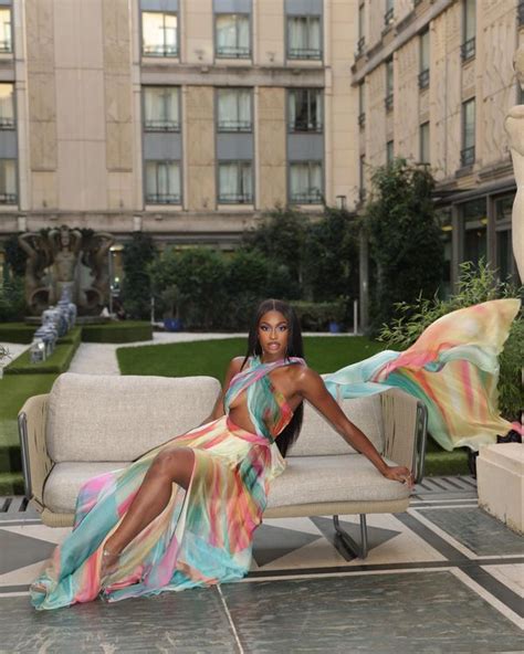 a woman in a colorful dress sitting on a couch