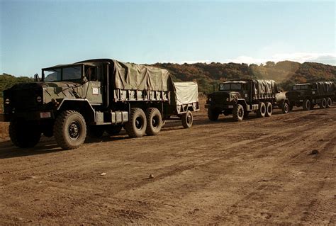 Left Side Front View Of A US Marine Convoy Of M923A1 6X6 5 Ton Cargo