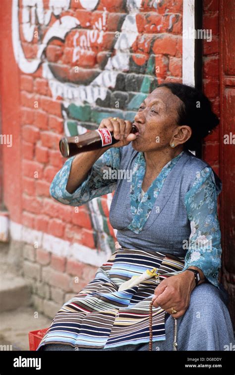 Woman Drinking Coca Cola From The Bottle Holding Rosarykathmandunepal