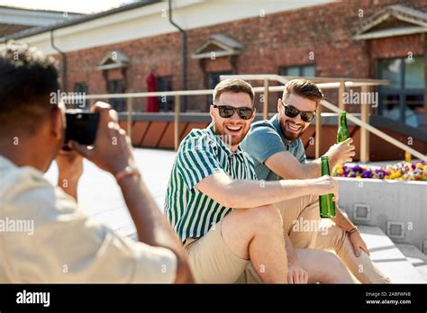 man photographing friends drinking beer on street Stock Photo - Alamy