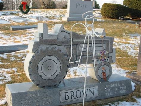 A Grave With A Tractor On It In The Snow