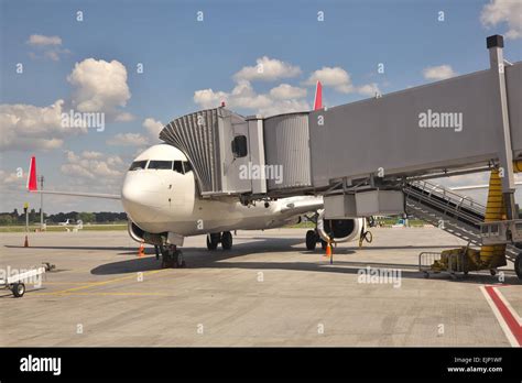 Passenger plane parked at the airport terminal boarding gate Stock ...