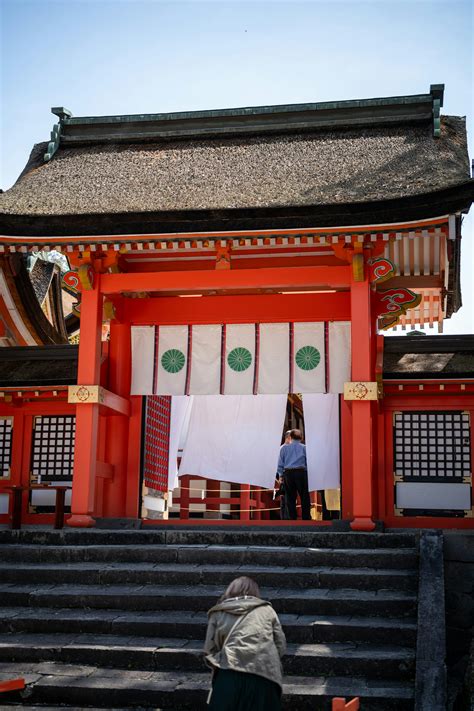 People visit and pray at a vibrant japanese shrine. photo – Free Image
