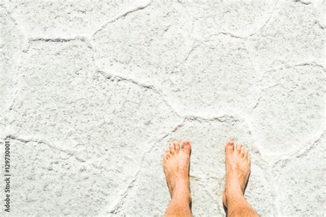 Naked Human Barefoot On Salt Surface Background At Tour Excursion In