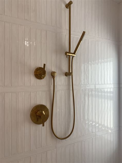 Luxurious White Tiled Bathroom with Gold Fixtures