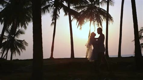 Married couple hugs on beach against sun... | Stock Video | Pond5