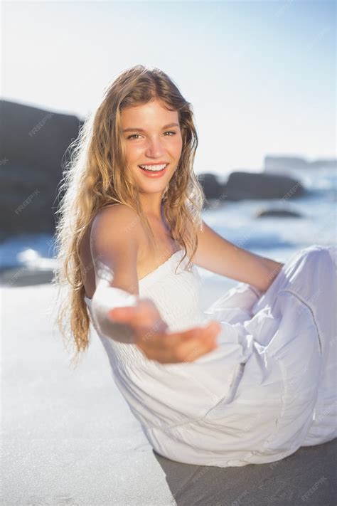 Premium Photo | Beautiful smiling blonde in sundress offering hand