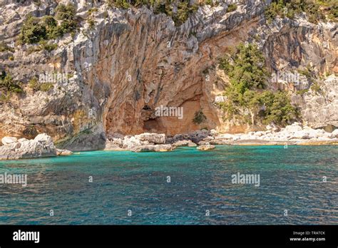 Cala Dei Gabbiani A Narrow Sandy Beach Below High Limestone Cliffs