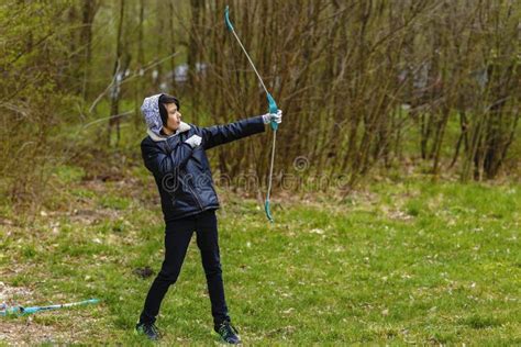 Boy Archer Shooting With His Bow At An Outdoor Stock Photo Image Of