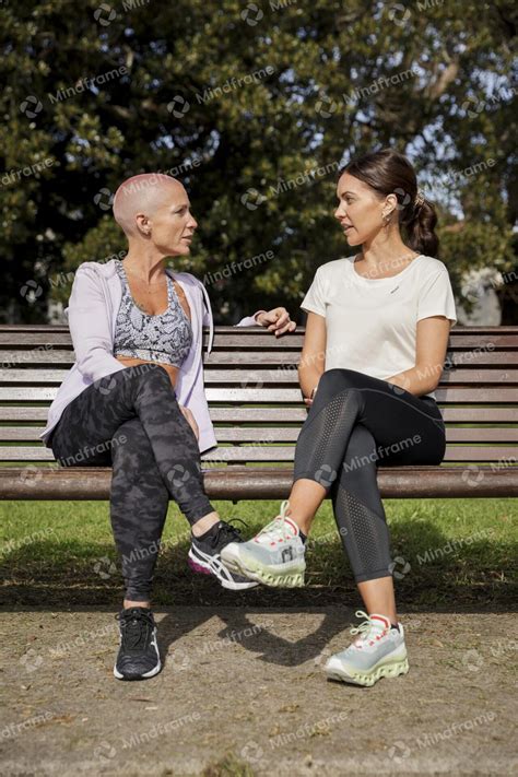 Two people talking, sitting on a park bench – Mindframe online image