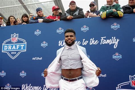 Ezekiel Elliott Brings His Trademark Hero In A Half Shirt Look To The