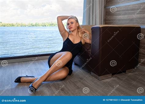 Nude Woman In White Jacket Posing In The White Chair Stock Photo