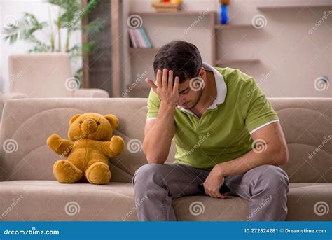 Young Man With Toy Bear At Home Stock Image Image Of Tired