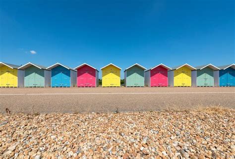 Prints Of A Row Of Multi Coloured Beach Huts Along The Promenade