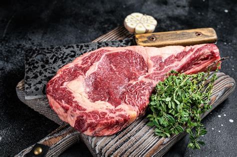 Premium Photo Dry Aged Tomahawk Rib Eye Steak Raw Beef Meat On