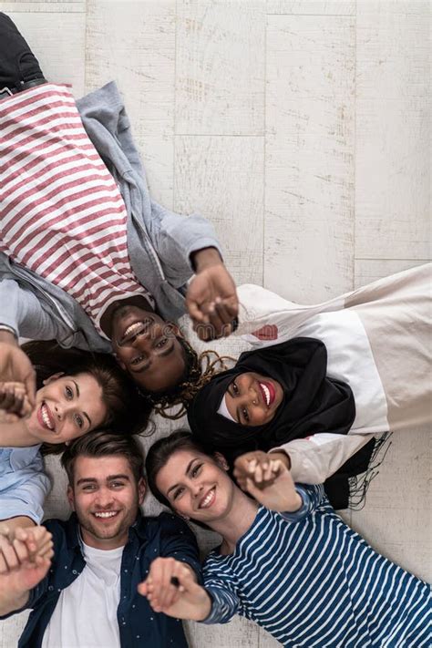 Top View Of A Diverse Group Of People Lying On The Floor And